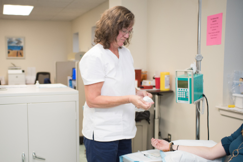 Phyllis Harrison, RN Anemia & Infusion Director, administering an infusion to a patient